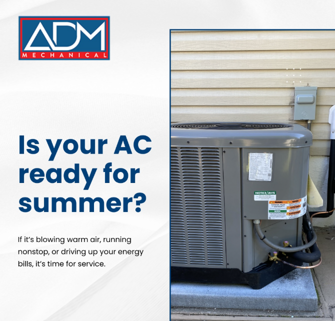 A gray air conditioner is sitting on a concrete platform outside of a house.