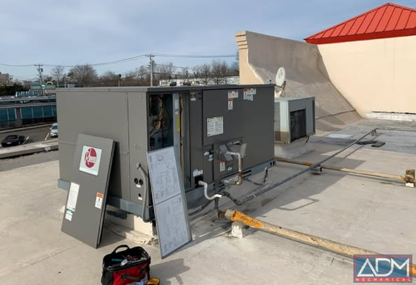 A fujitsu air conditioner is mounted on the side of a house.