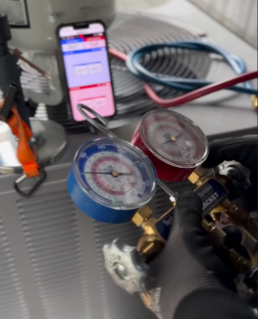 A fujitsu air conditioner is mounted on the side of a house.