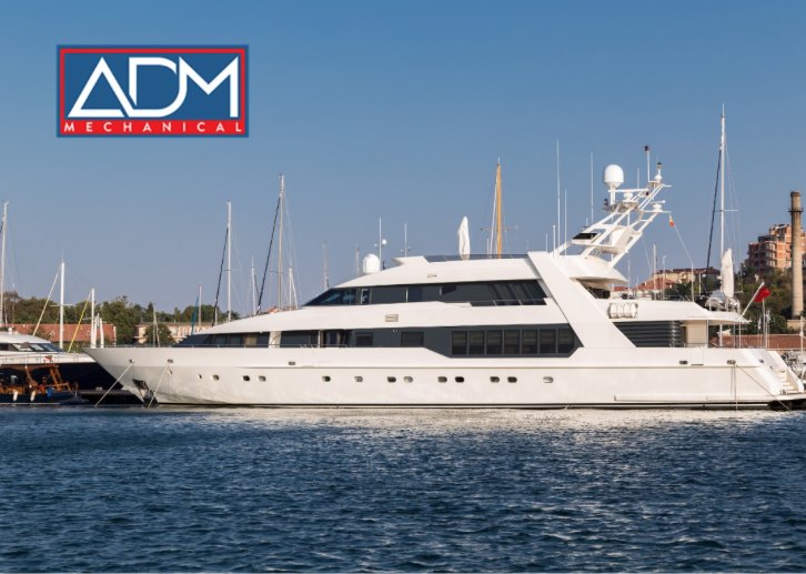 A gray air conditioner is sitting on a concrete platform outside of a house.