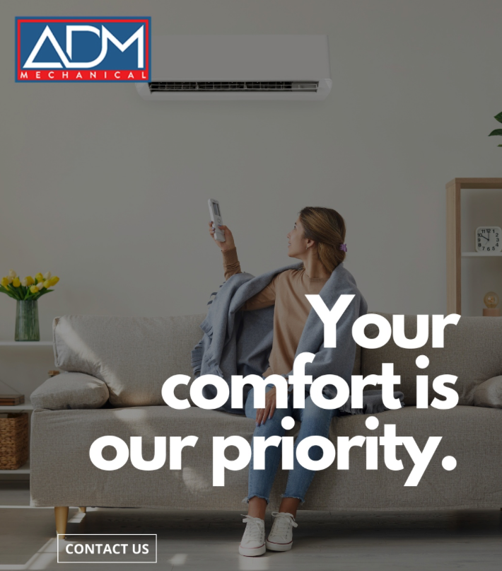 A gray air conditioner is sitting on a concrete platform outside of a house.