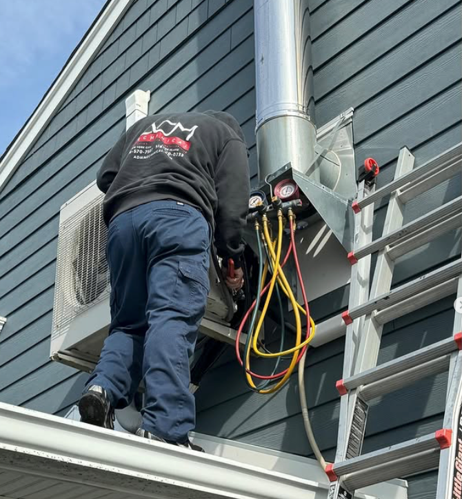 A fujitsu air conditioner is mounted on the side of a house.