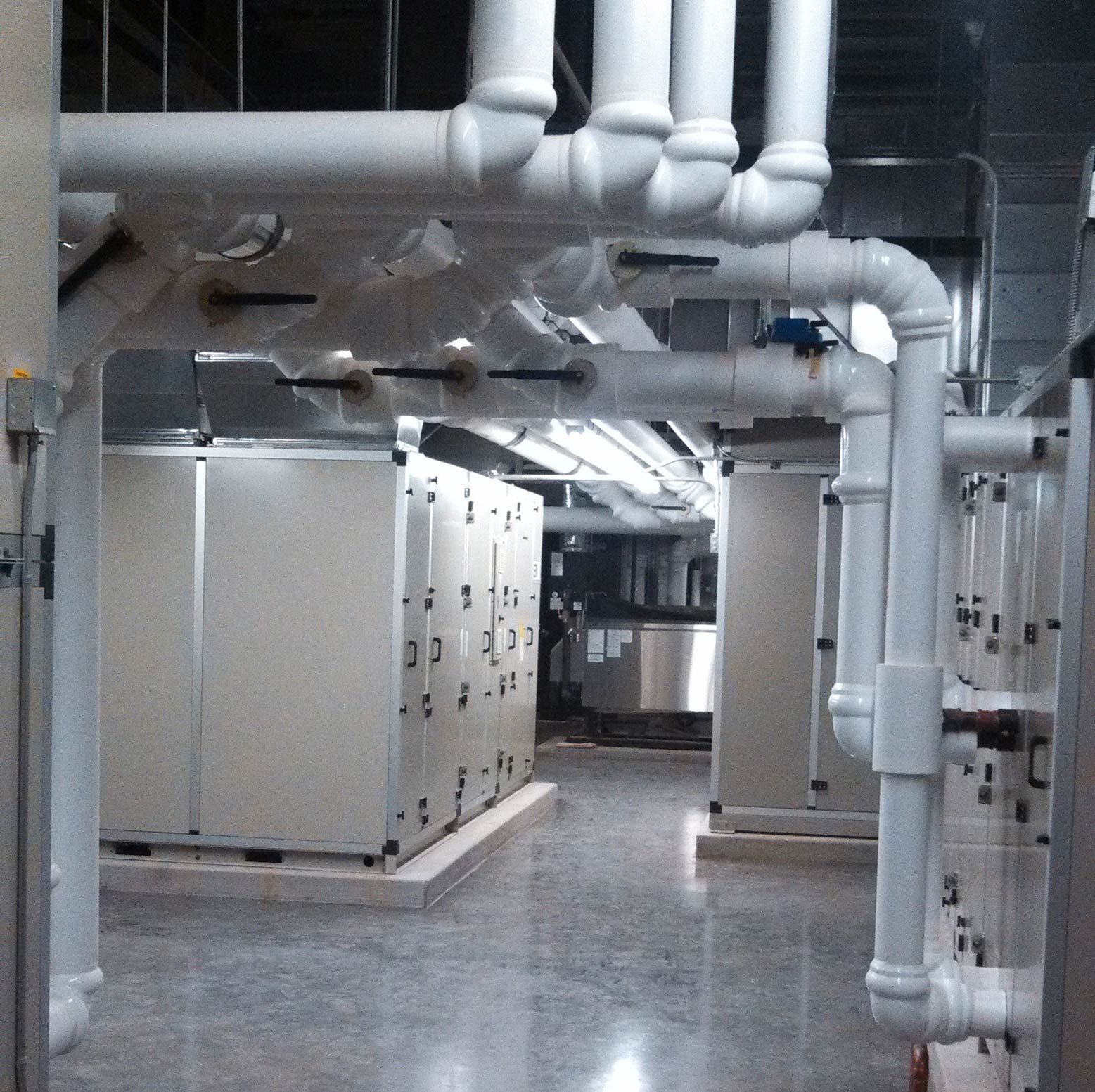 A room with a lot of pipes going through it