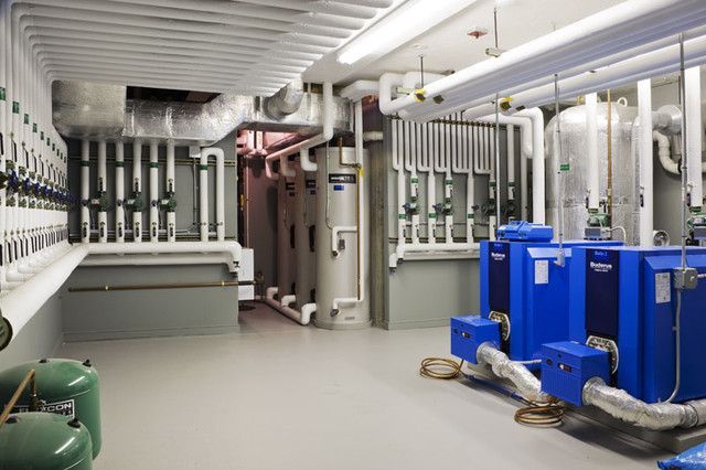 A room with a lot of pipes and machinery in it