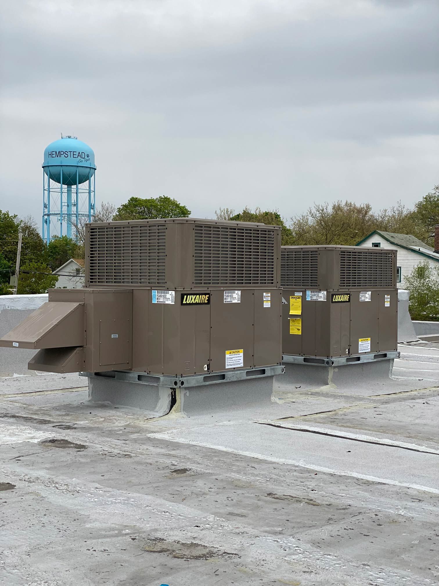A rooftop with a water tower in the background
