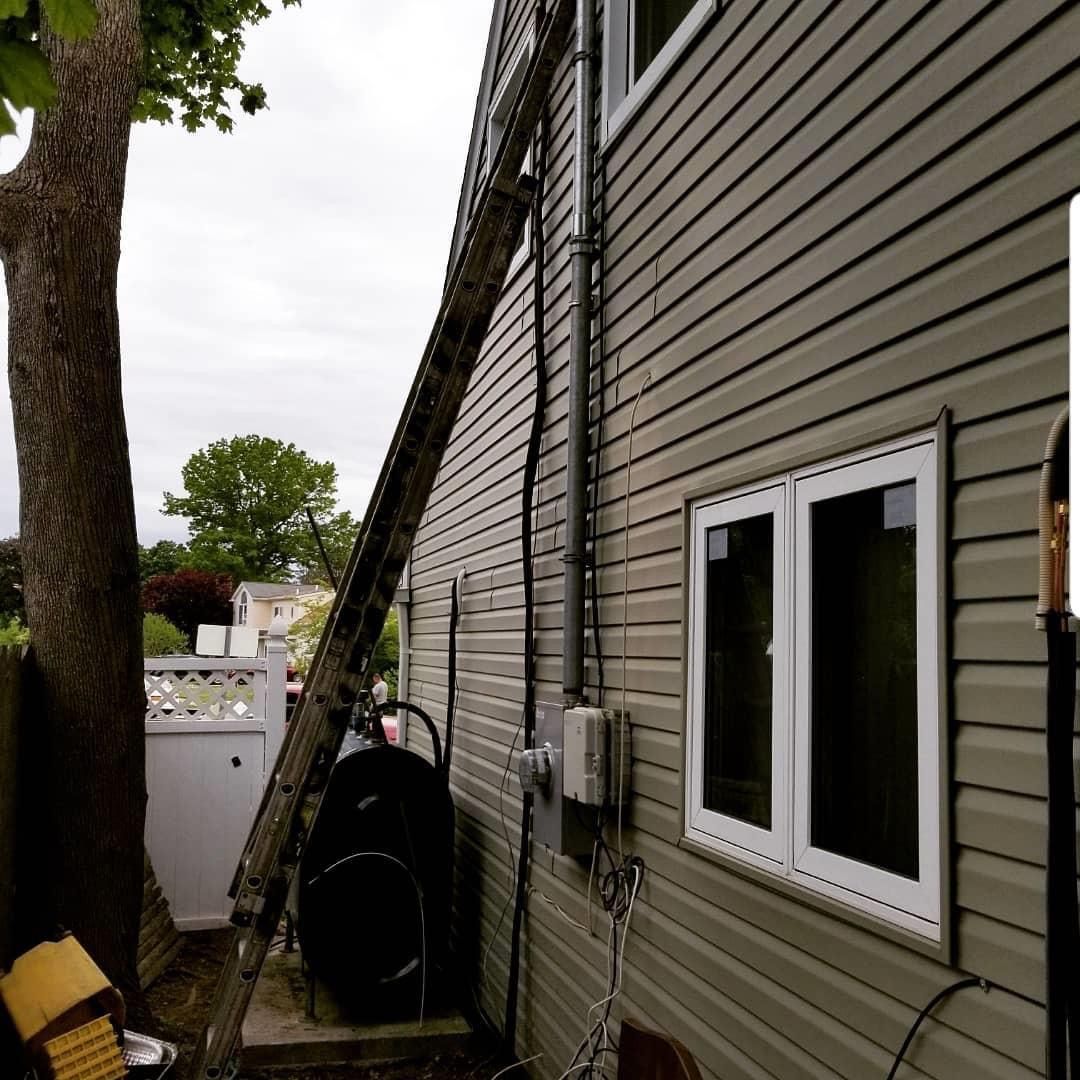 A ladder is leaning against the side of a house