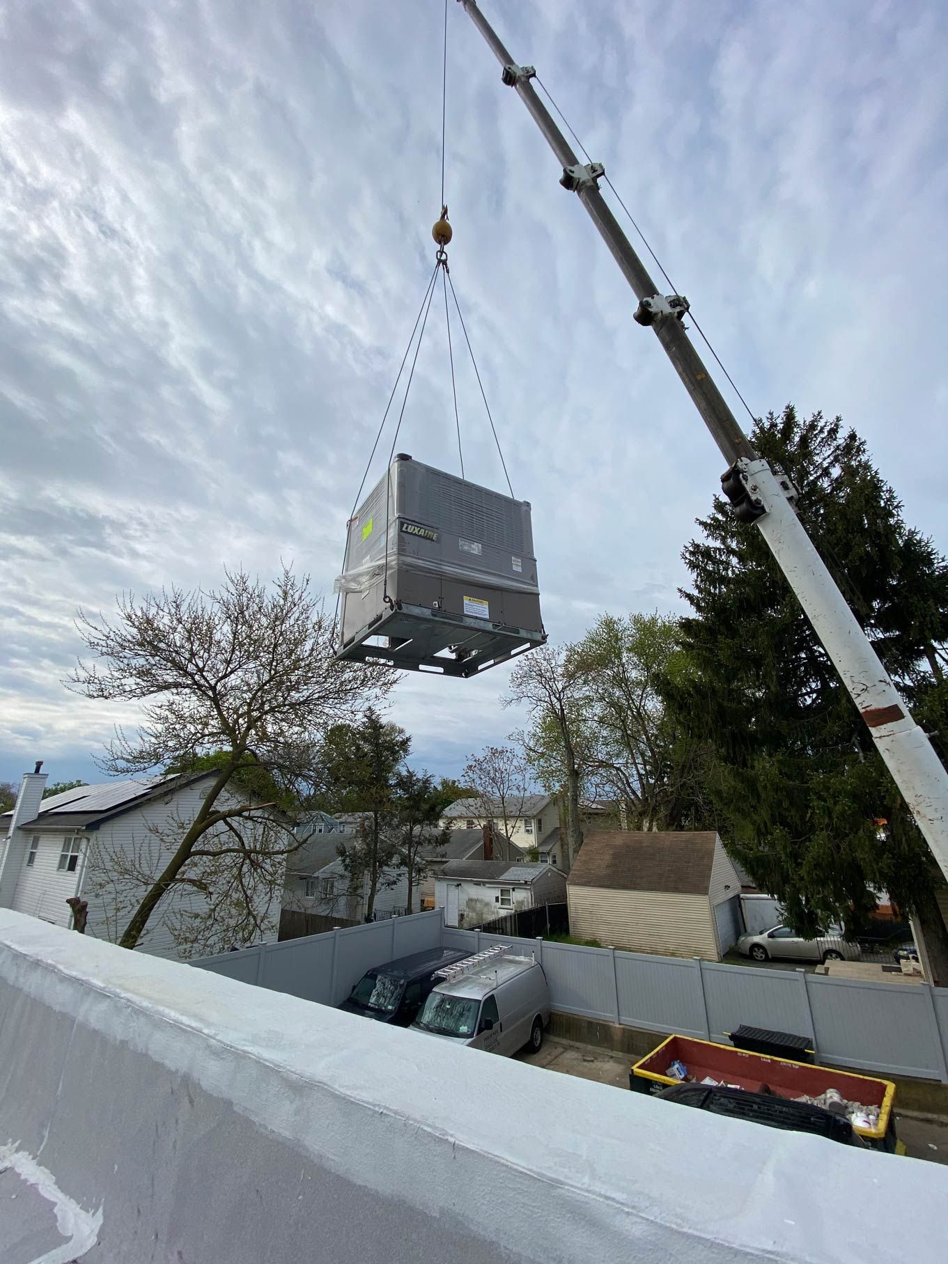 A crane is lifting a large box into the air.