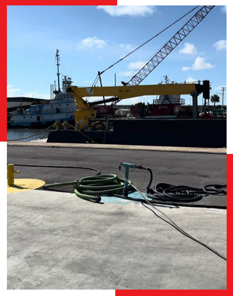 A large yellow crane is sitting on the side of the road
