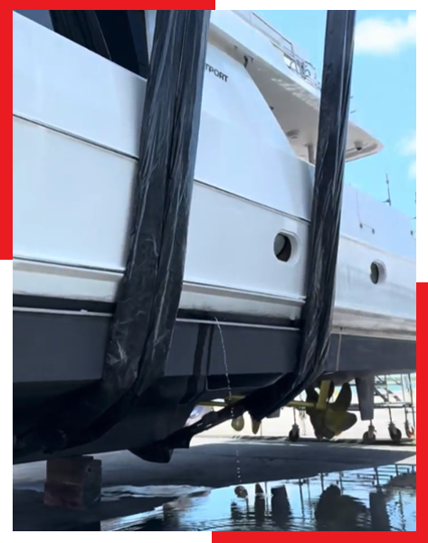 A large white boat is being lifted by a crane