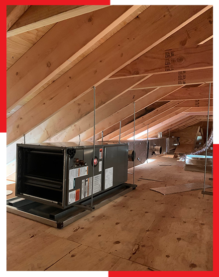 An air conditioner is sitting in the attic of a house under construction