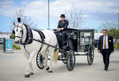 Ralph Torres walking with carriage for funeral in CA