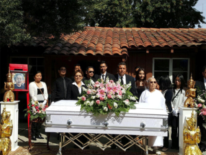 Asian family with staff of Torres Cremation and Burial Services saying goodbye to loved one at Torres Cremation and Burial Services CA