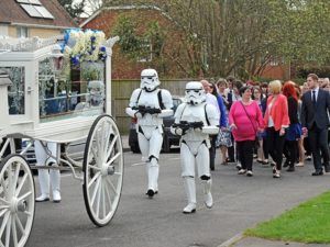 Storm troopers walking beside carriage of loved one for final goodbye at Torres Cremation and Burial Services CA