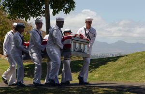 Veteran Funeral Services with navy men carrying casket of fallen veteran at Torres Cremation and Burial Services CA