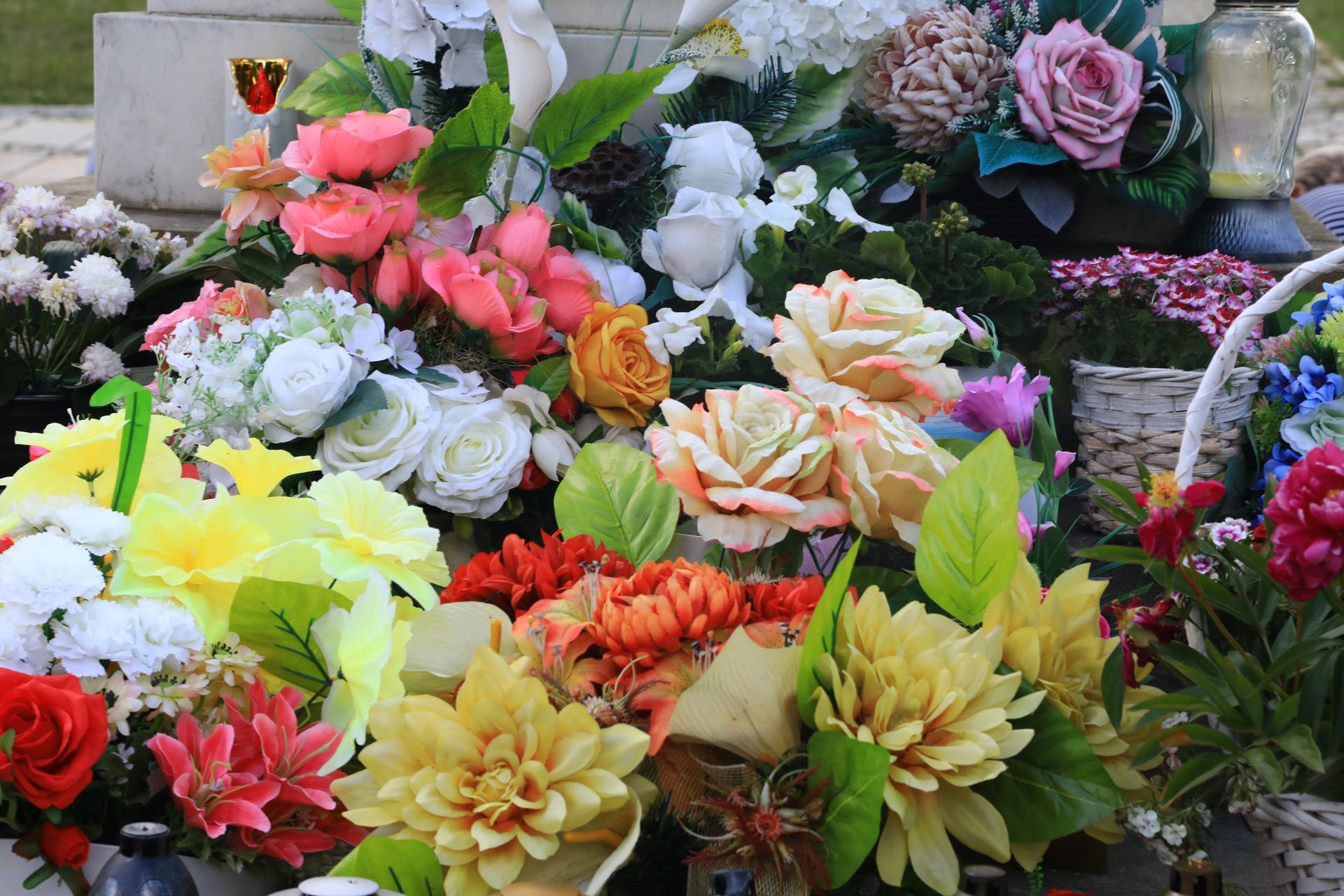 Arrangement of colorful artificial flowers on a grave. Arrangement of colorful artificial flowers on a grave.