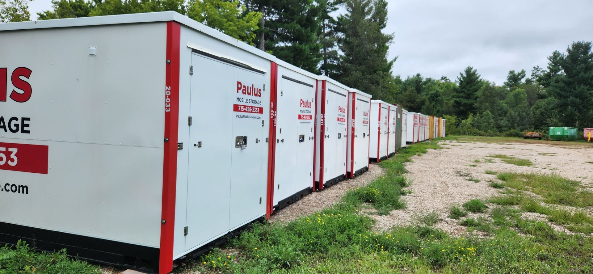 A semi truck is parked in front of a house with a garage.