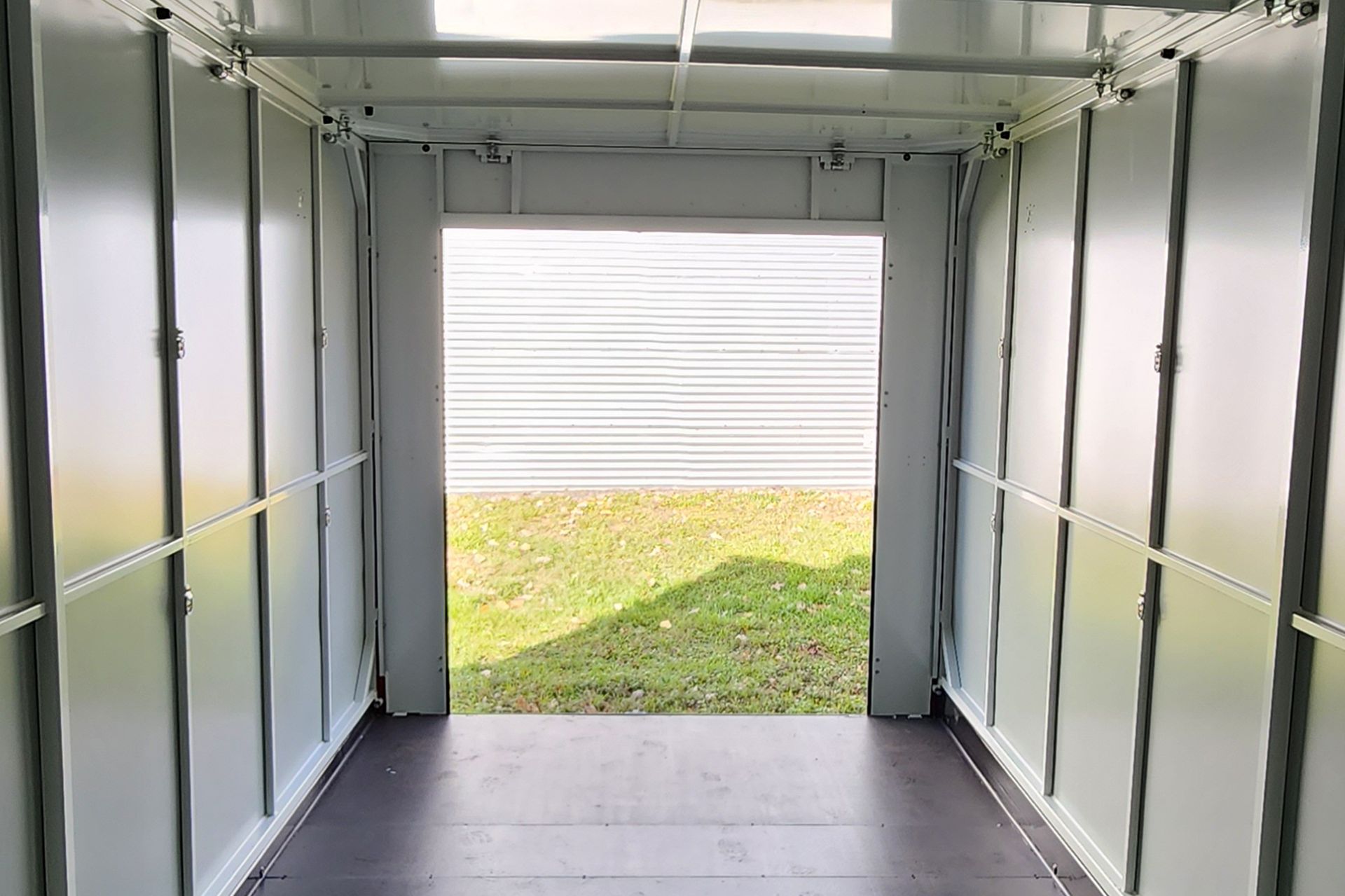 The inside of a garage with the door open.