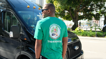 Hop on Hop off Sightseeing Miami Tour Bus Driver and Black Bus in Bayside