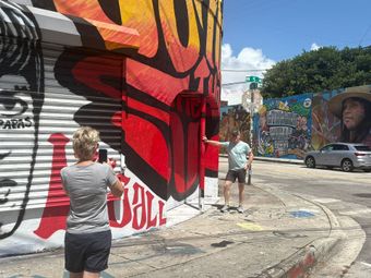 Guest in Wynwood Walls, taking photos in the Murals