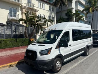 Sightseeing hop on hop off bus parked in front of the Versace Mansion