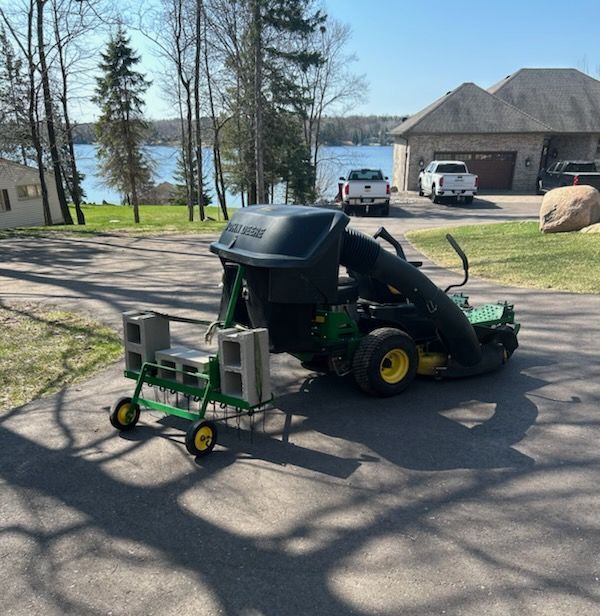 A john deere lawn mower is parked in a driveway
