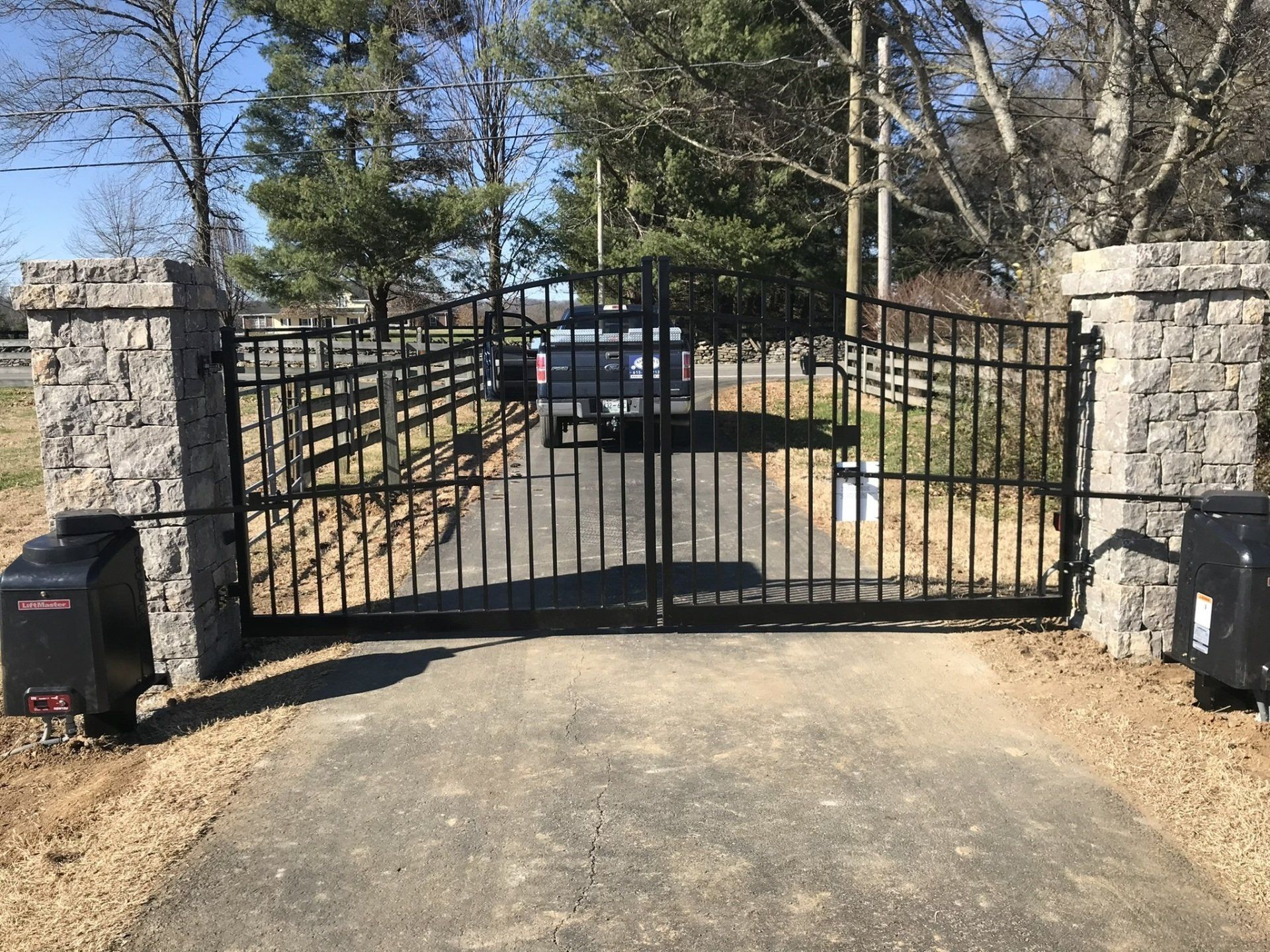 a truck is parked in front of a metal gate .
