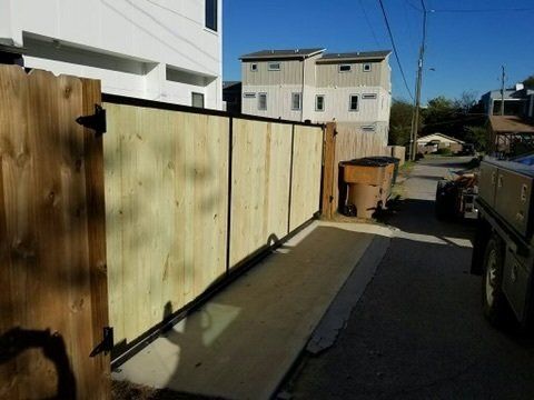 a wooden fence is sitting on the side of a road .