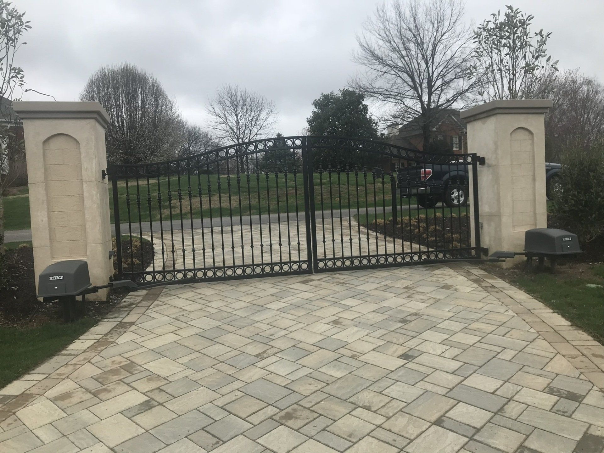 a brick driveway with a gate in the middle of it