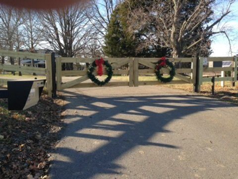 a wooden fence with christmas wreaths on it