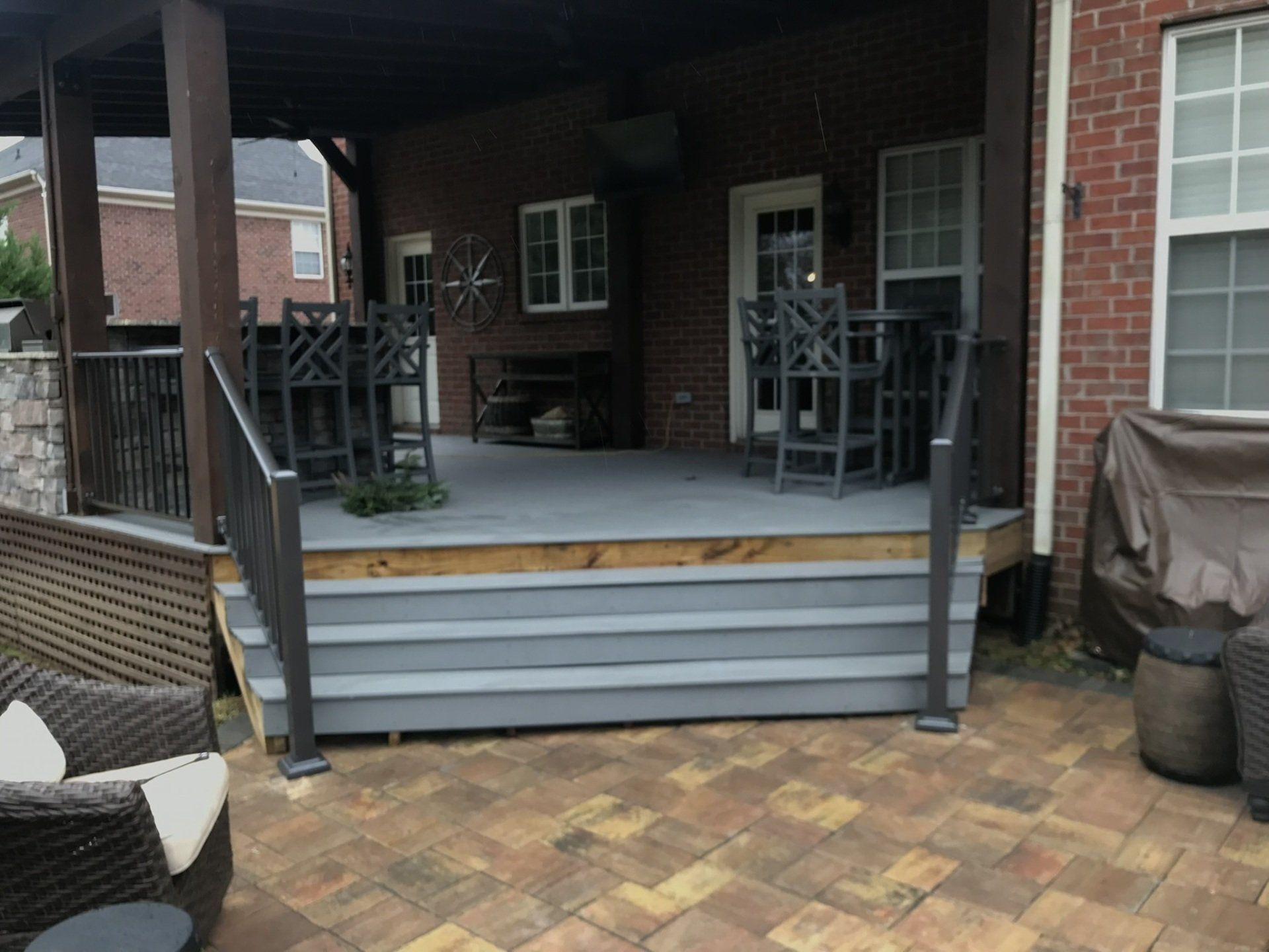 a brick house with a porch and stairs