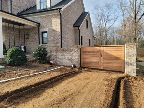 a brick house with a wooden gate in front of it .