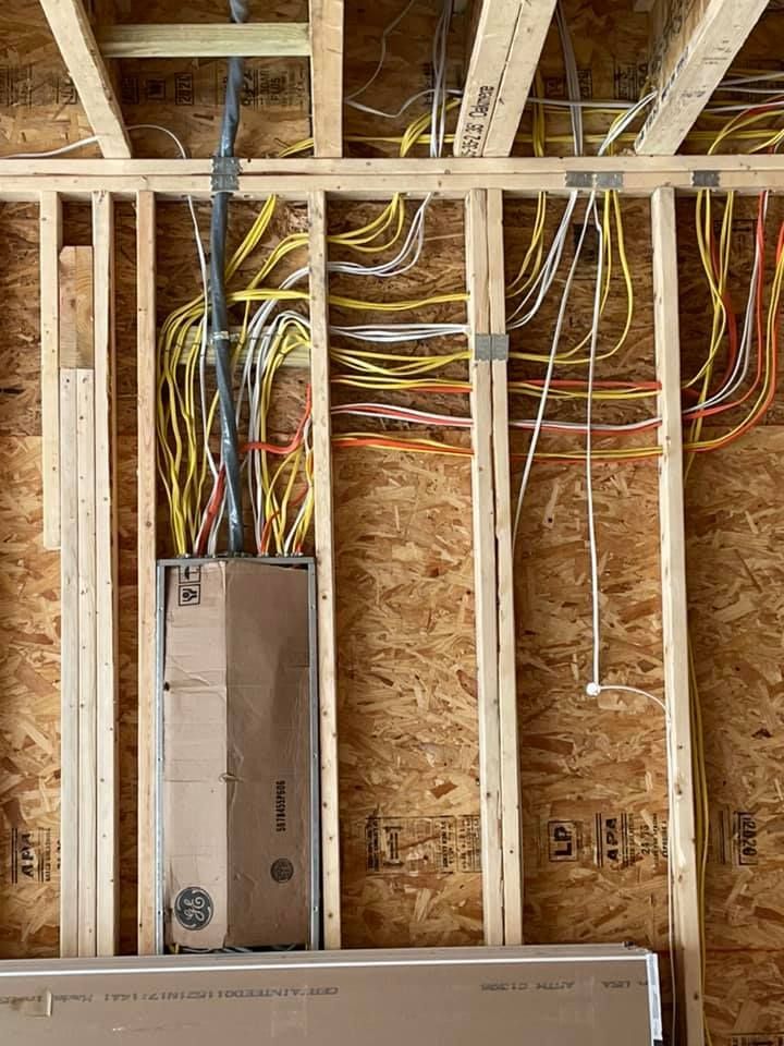 A bunch of wires are hanging from the ceiling of a building.