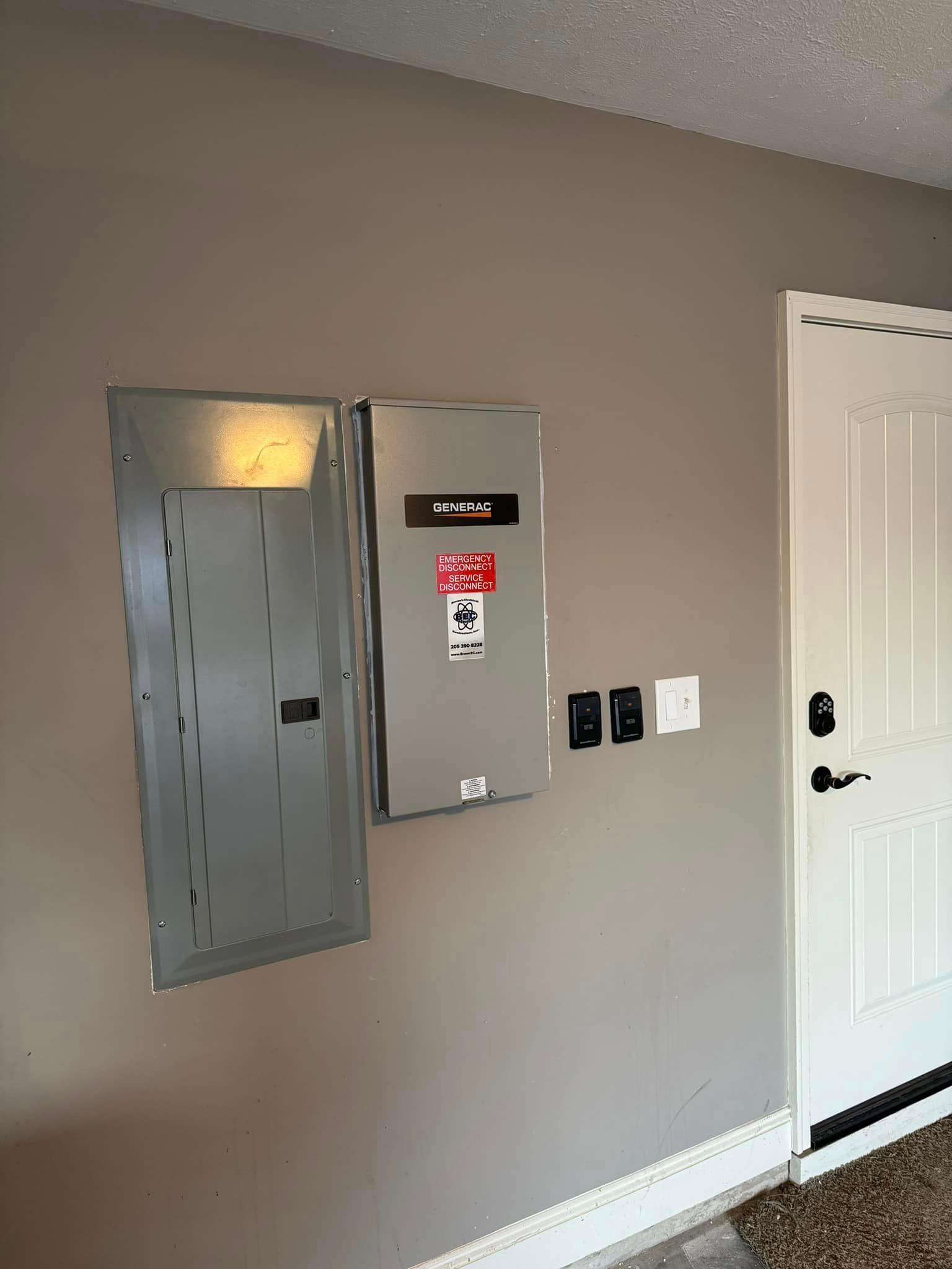 There is a electrical box on the wall next to a door.