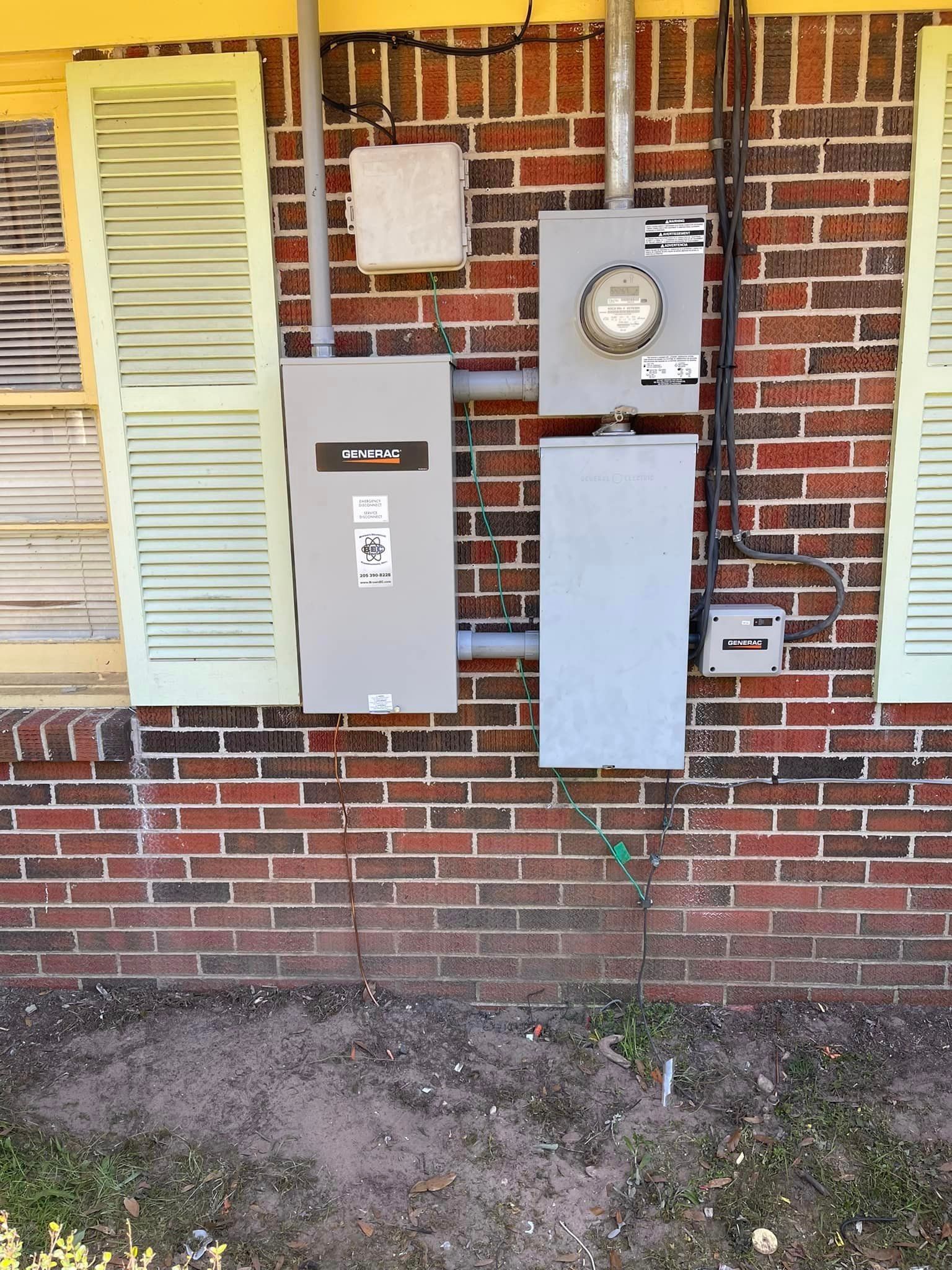 A brick wall with a meter and a box on it.