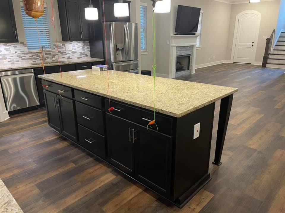 There is a large island in the middle of the kitchen.