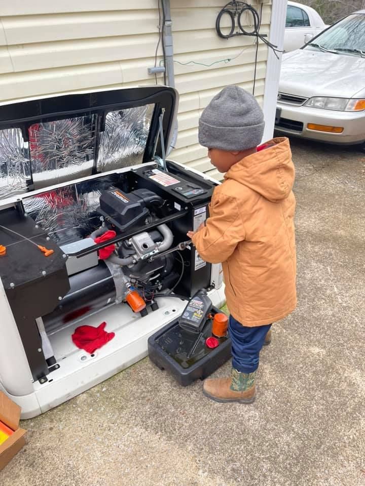 A little boy is playing with a toy car engine.