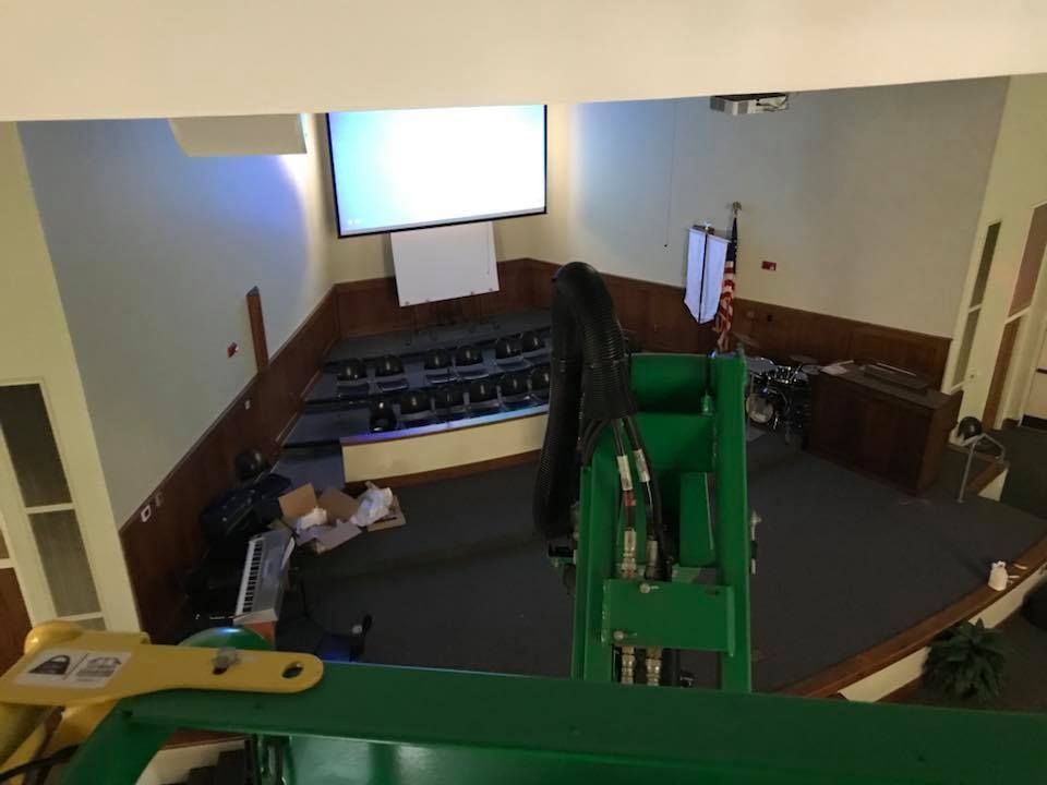 An aerial view of a room with a projector screen on the wall.
