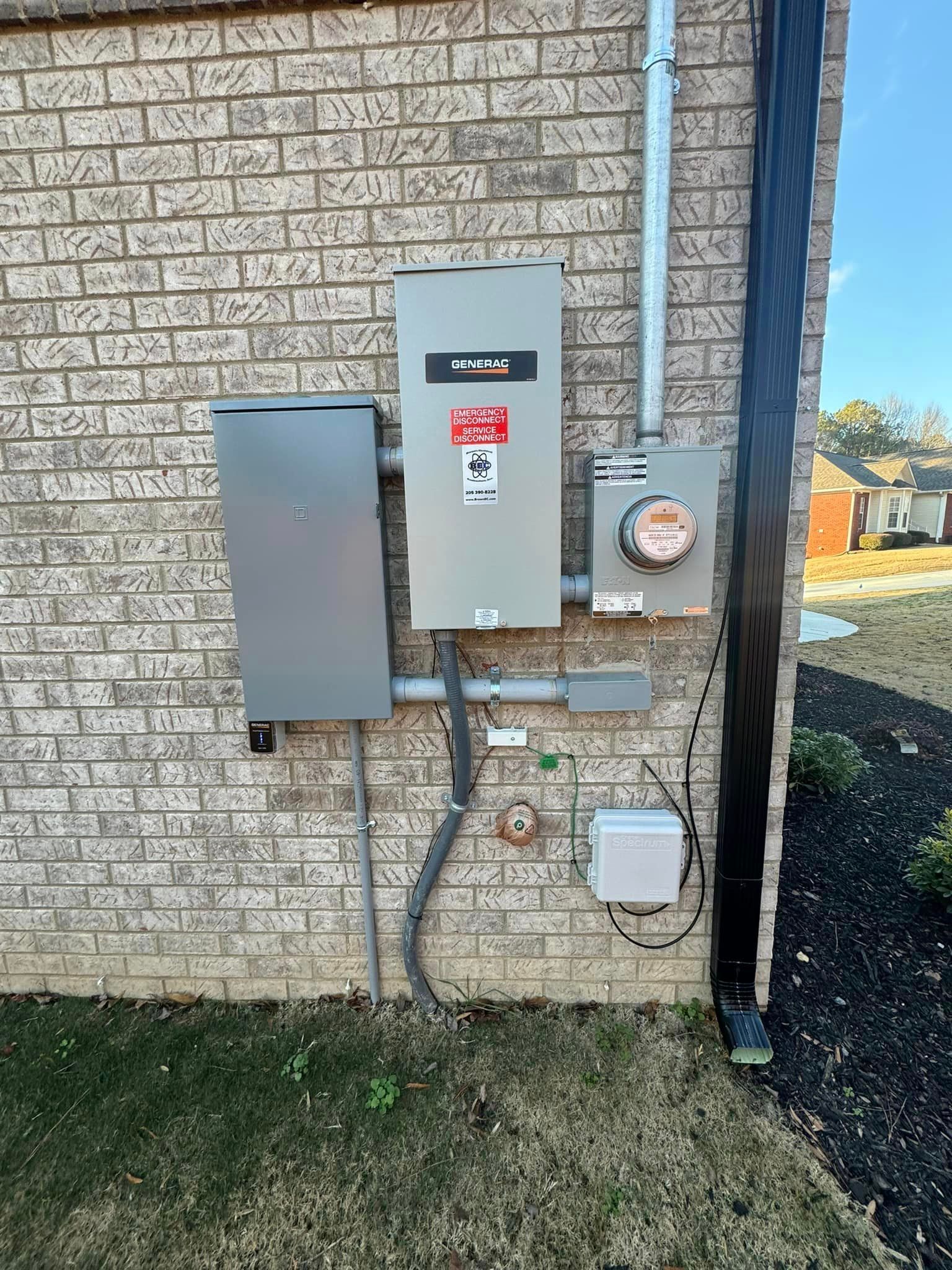 A brick building with a electrical box on the side of it.