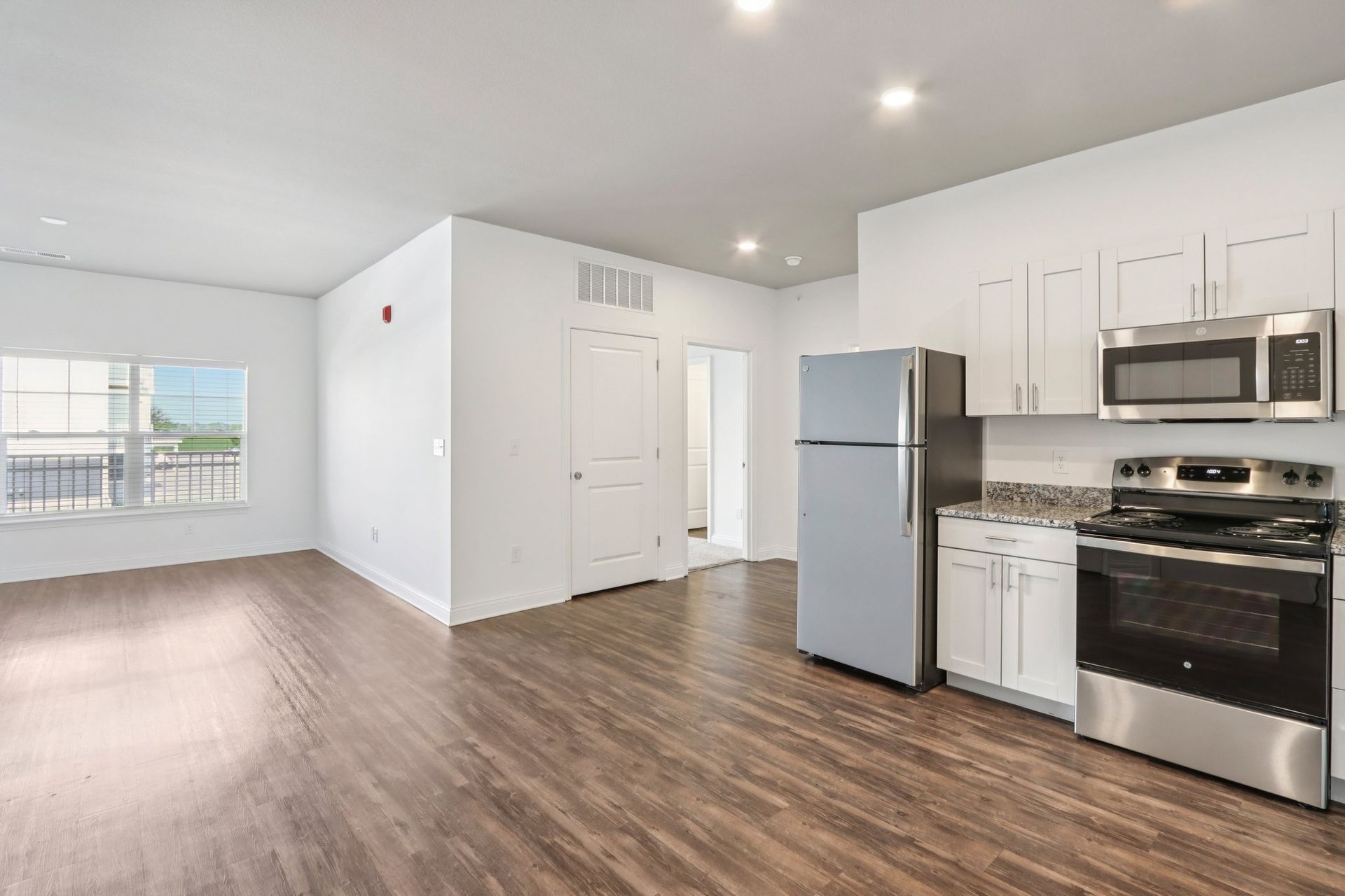 A kitchen with stainless steel appliances and granite counter tops.