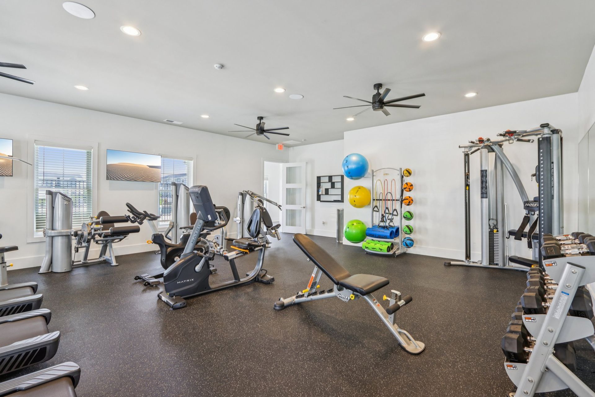 A large gym with a lot of treadmills and exercise equipment.