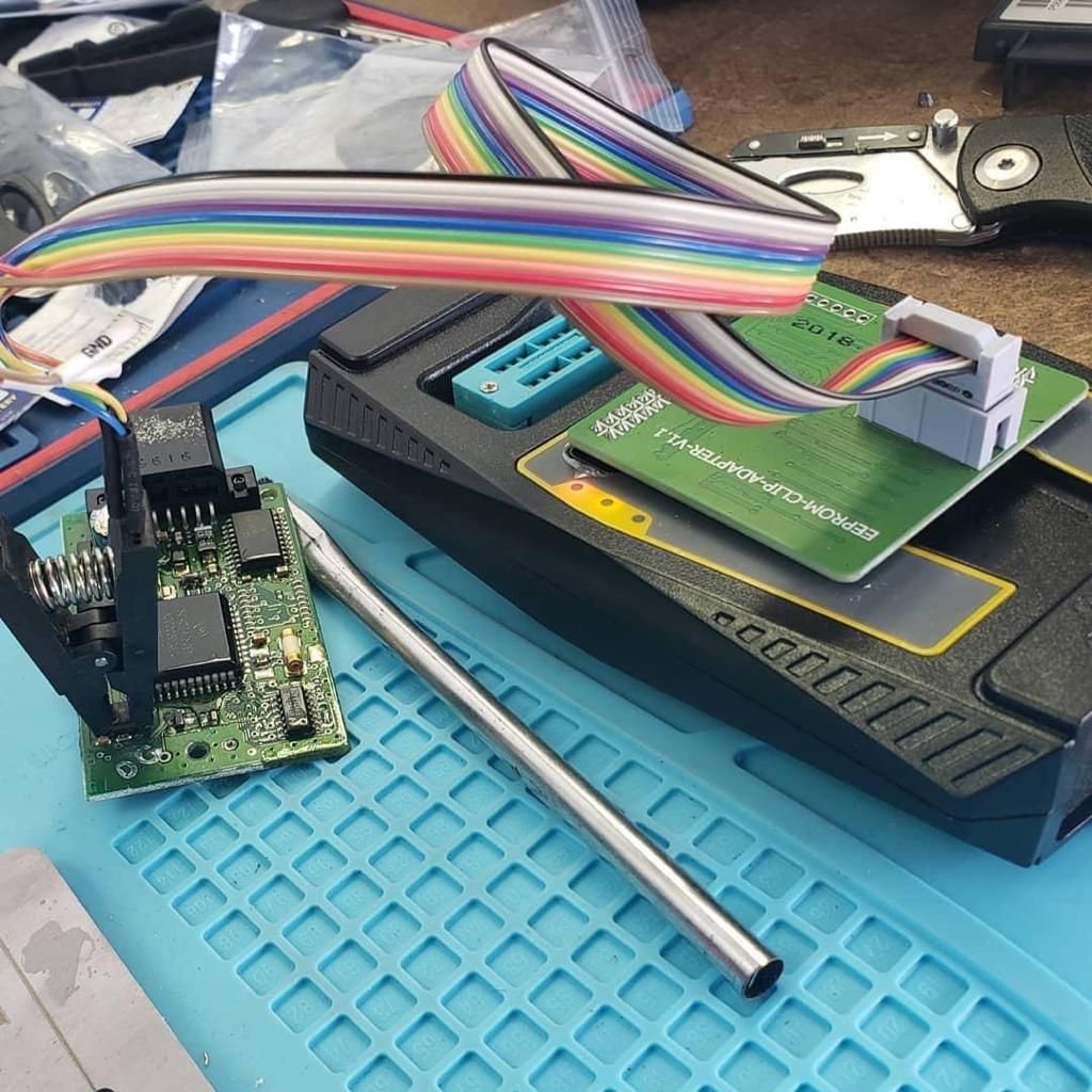 A rainbow colored wire is sitting on top of a computer chip.
