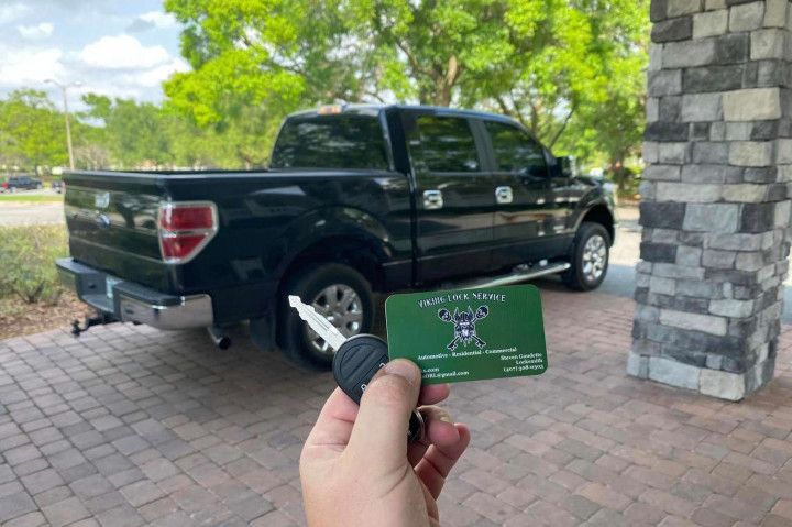 Black Pick-up on the background, car keys and Viking Lock Service business card