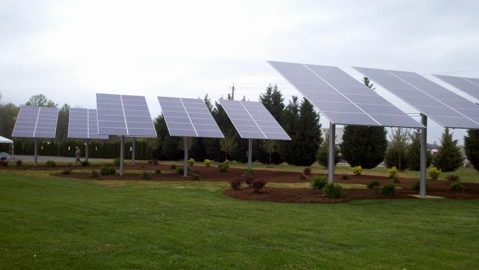 A row of solar panels in a grassy field