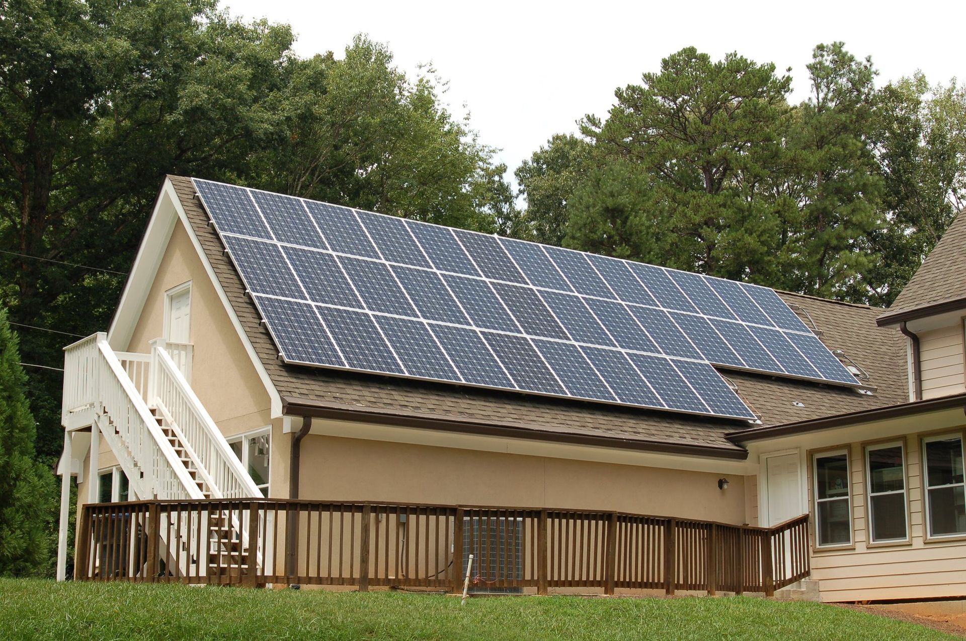 A house with a lot of solar panels on the roof