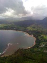 An aerial view of a large body of water surrounded by mountains.