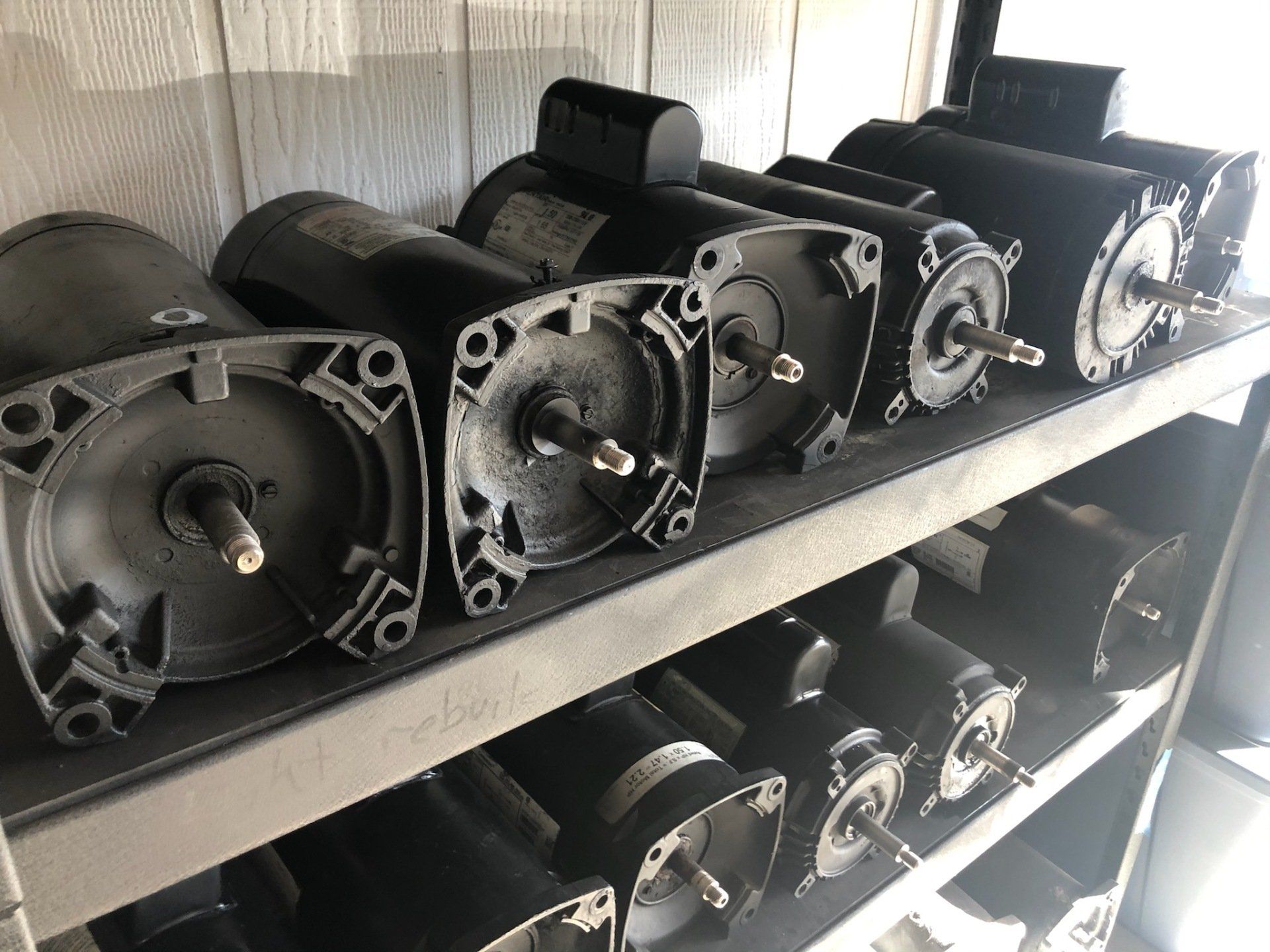 A shelf filled with lots of different types of motors.
