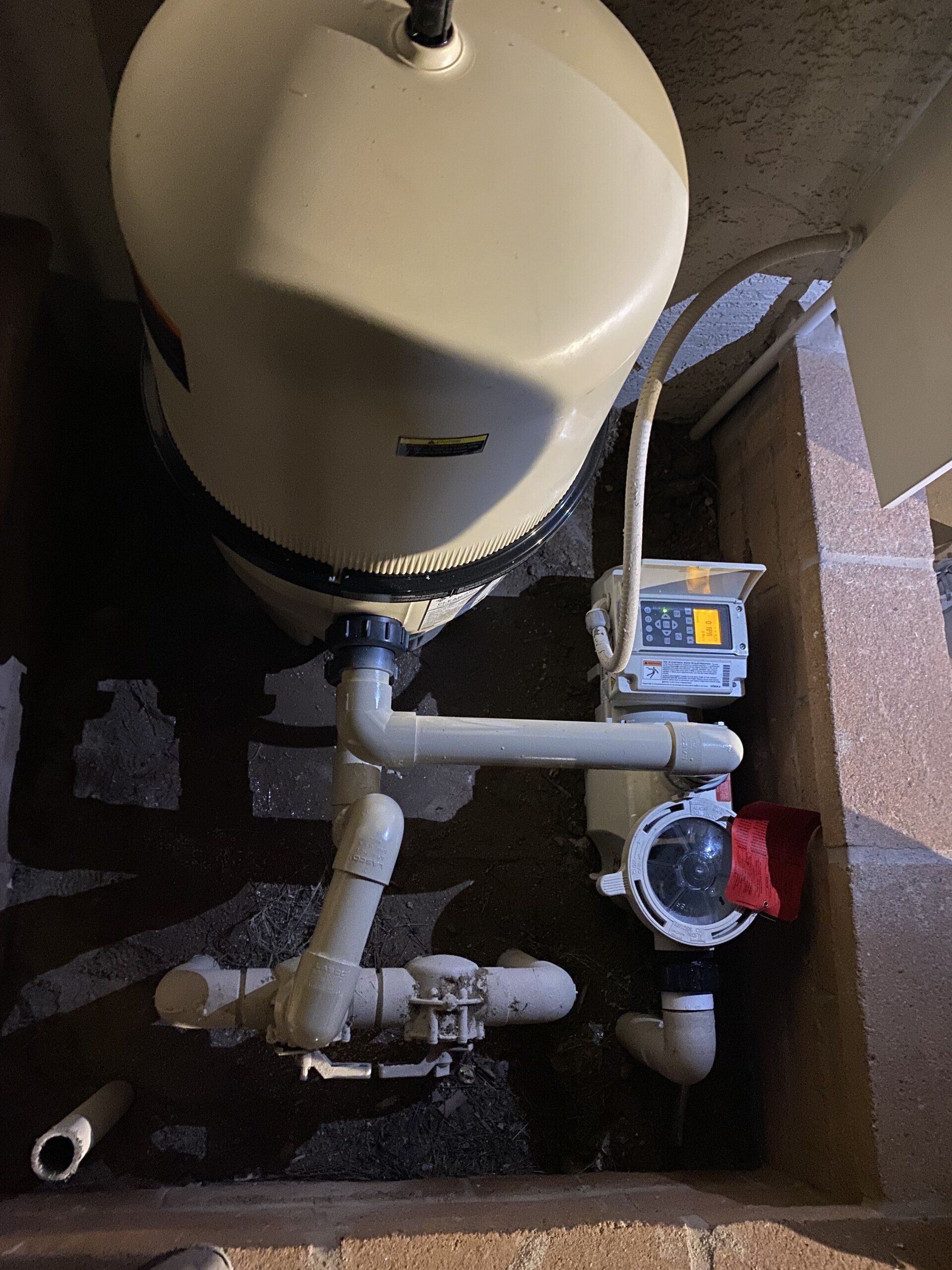 A close up of a water pump with pipes attached to it