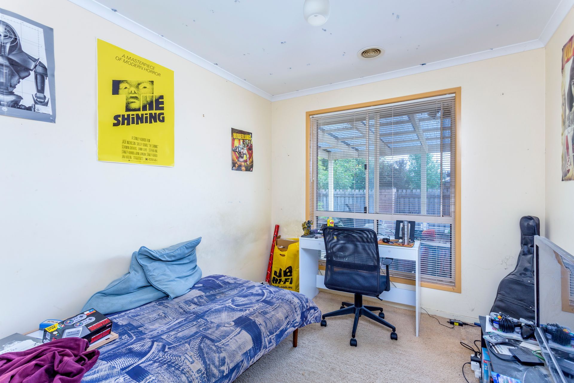 Bathroom with tub, shower, and vanity. Pale blue tiled walls, window, and neutral tones.