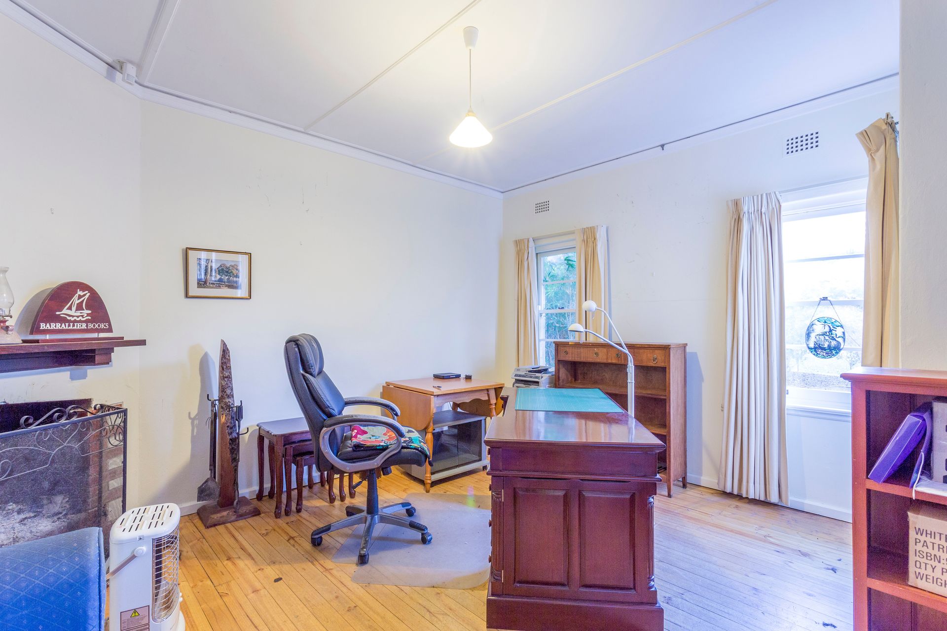 A small outdoor patio with a blue planter, sliding glass door, and a white handrail.