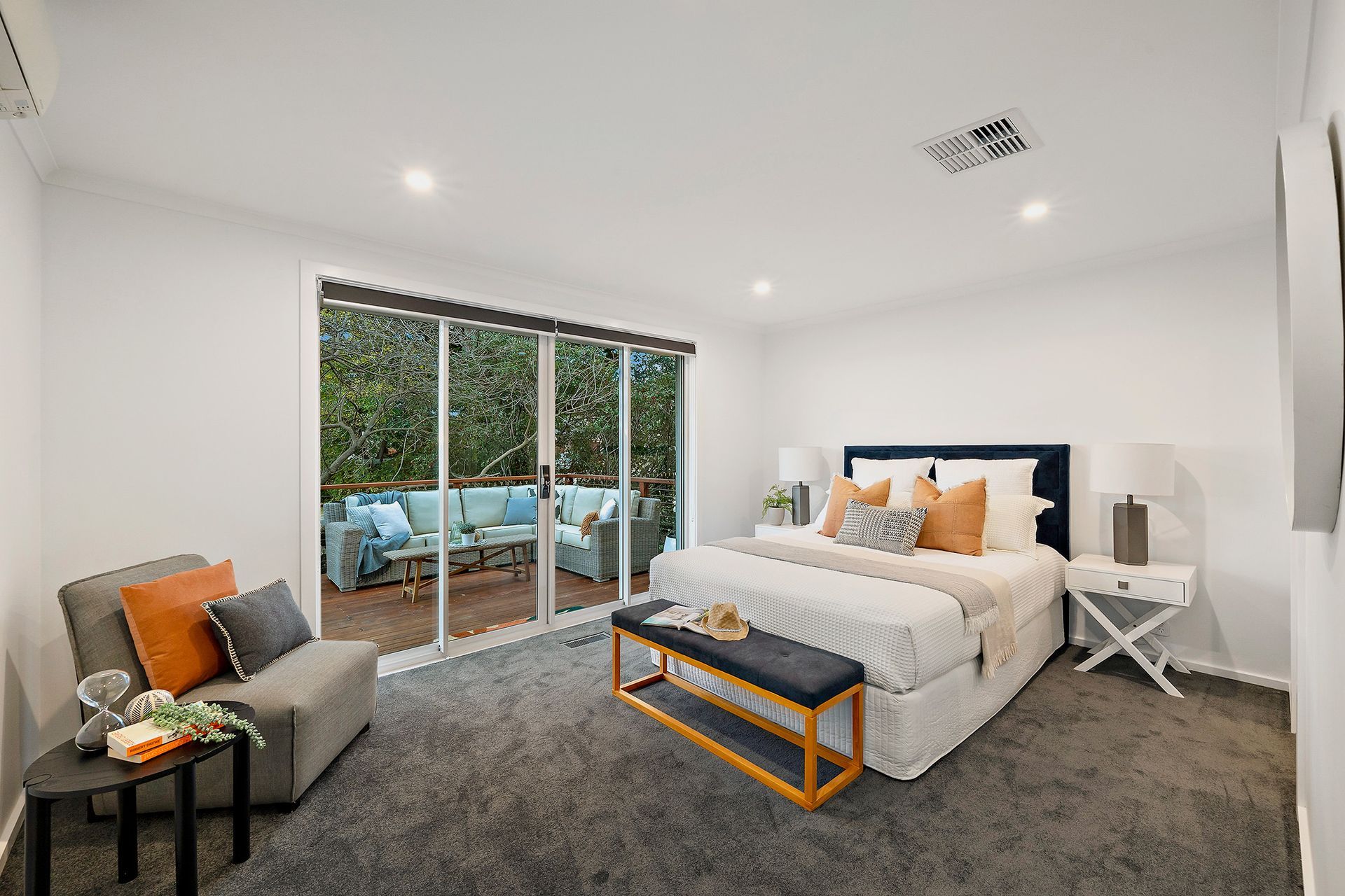 Modern bathroom with wood vanity, glass shower, and neutral tile.